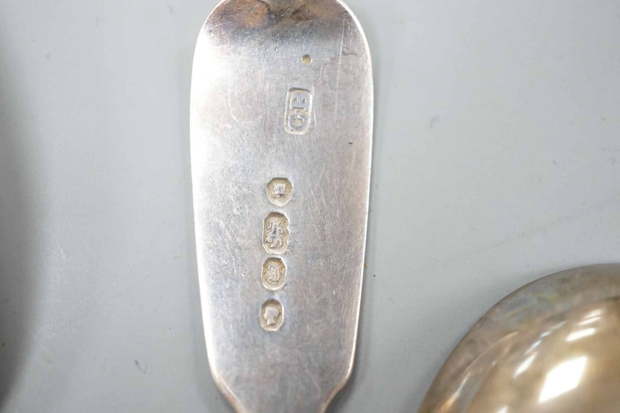 A set of six early Victorian silver fiddle pattern teaspoons, Charles Boyton, London, 1844 and a George IV silver caddy spoon, Birmingham, 1821, 3.5oz.